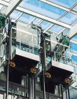 Modern elevator glass cabins in a contemporary business center