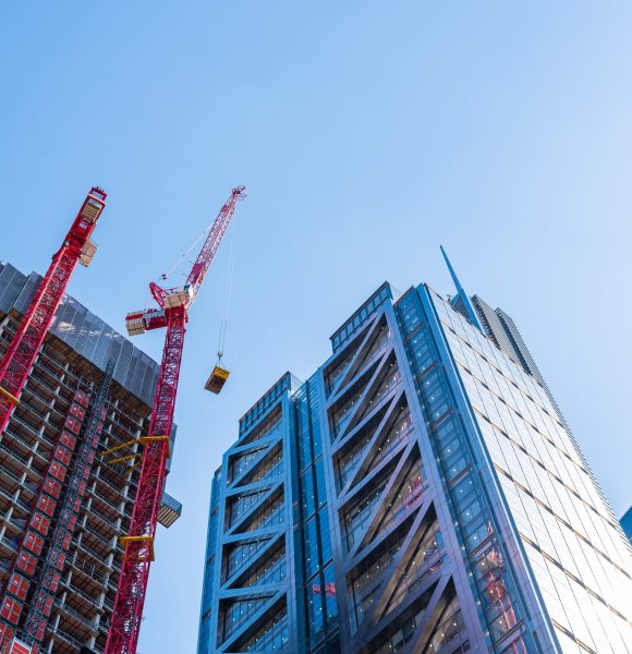London, UK - May 14, 2019: Low angle view of office buildings under construction in the City of London against blue sky.